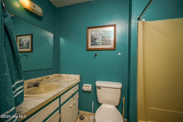 bathroom featuring vanity, a shower, and toilet