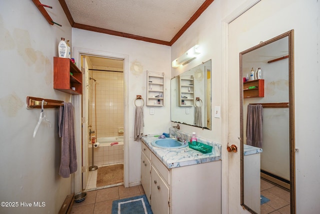 bathroom with crown molding, tile patterned flooring, tiled shower / bath combo, vanity, and a textured ceiling