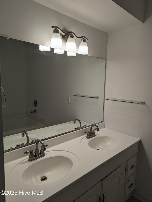 bathroom with vanity and a washtub