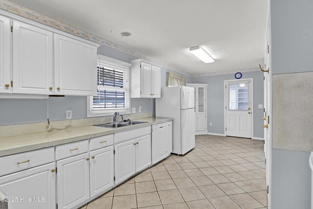 kitchen featuring light tile patterned flooring, white appliances, sink, and white cabinets