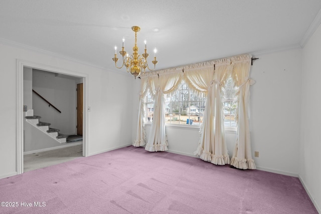 carpeted spare room featuring an inviting chandelier and ornamental molding