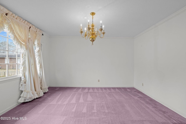 carpeted empty room featuring ornamental molding and a chandelier