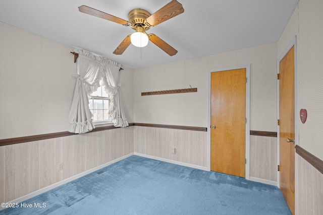 empty room featuring ceiling fan and carpet flooring