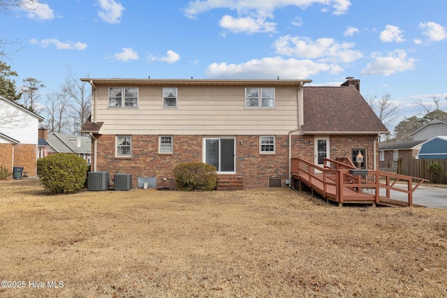 rear view of house featuring a wooden deck, a yard, and central AC