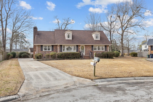 new england style home featuring a front yard