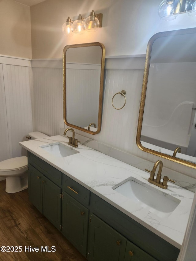 bathroom featuring hardwood / wood-style flooring, vanity, and toilet