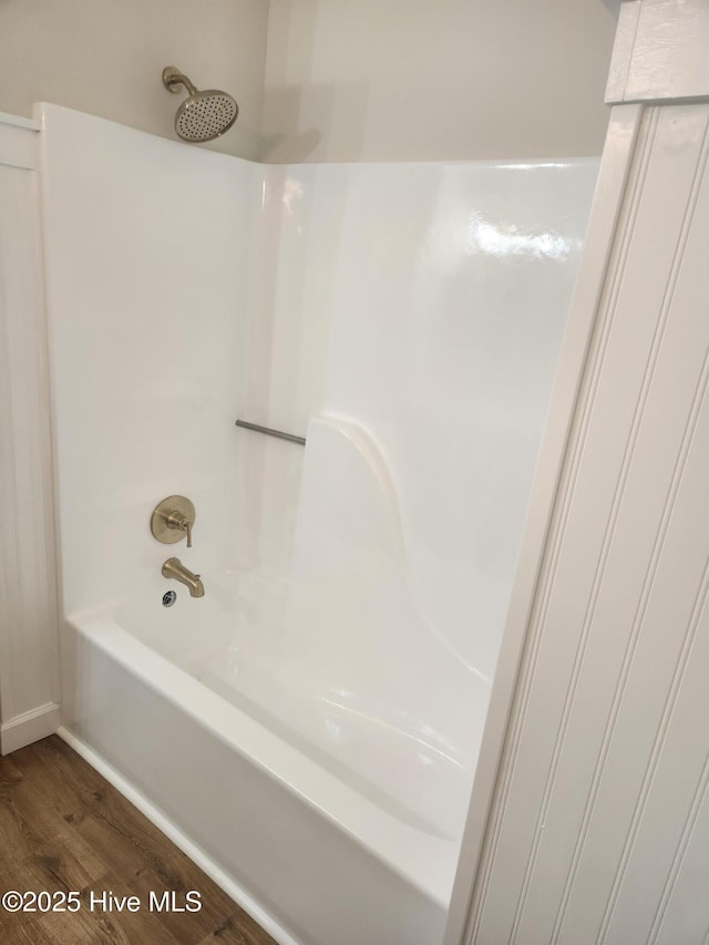 bathroom featuring shower / bathing tub combination and hardwood / wood-style floors