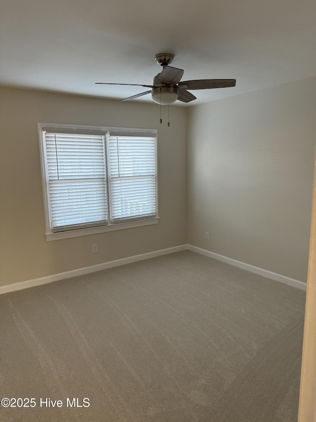 carpeted spare room with ceiling fan