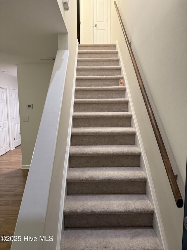 stairway featuring hardwood / wood-style floors