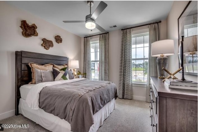 bedroom with light carpet and ceiling fan