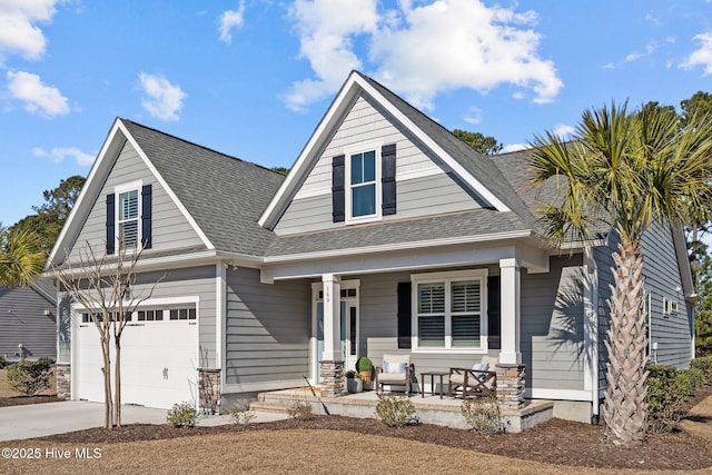 view of front of house featuring covered porch, roof with shingles, and driveway