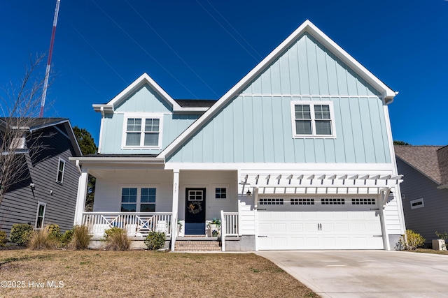 modern farmhouse featuring a garage, board and batten siding, a porch, and concrete driveway