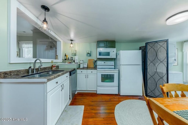 kitchen featuring sink, hanging light fixtures, kitchen peninsula, white appliances, and white cabinets