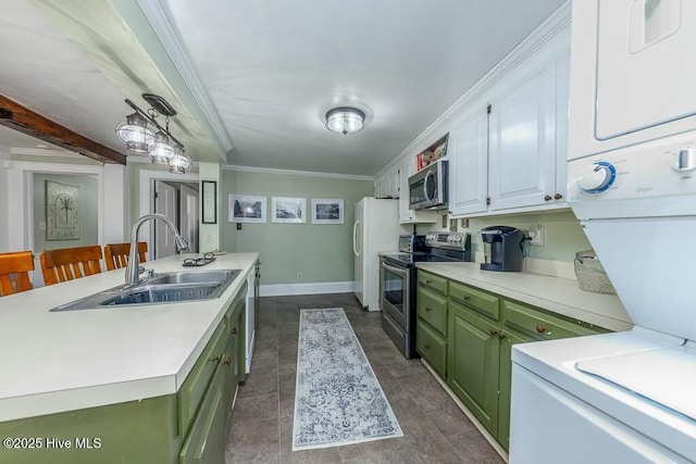 kitchen with stacked washing maching and dryer, white cabinetry, sink, green cabinets, and stainless steel appliances