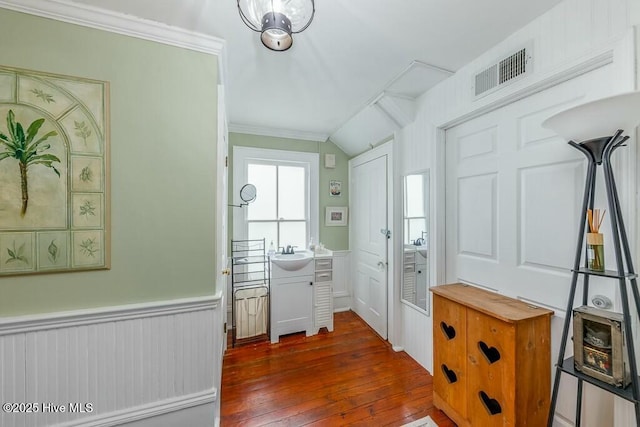 interior space featuring crown molding, lofted ceiling, sink, and dark hardwood / wood-style floors