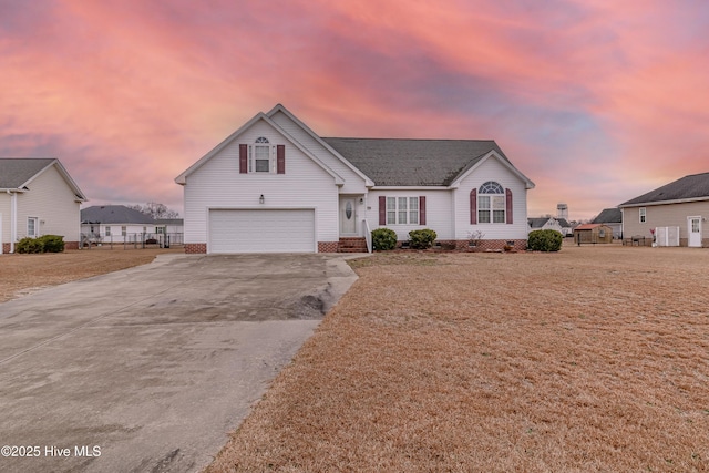 view of front facade with a garage and a yard