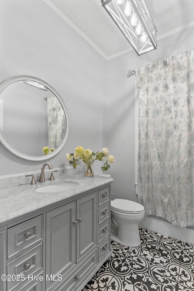 bathroom featuring crown molding, vanity, tile patterned floors, and toilet