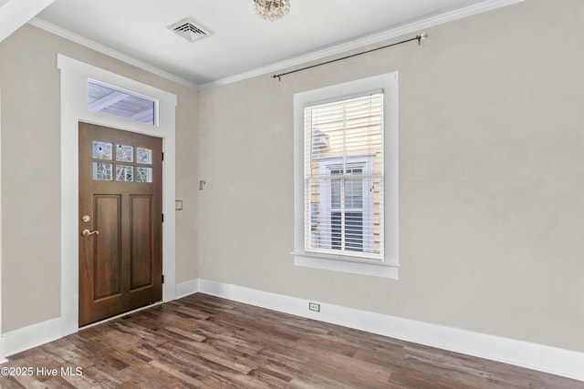 foyer entrance with crown molding and dark hardwood / wood-style flooring