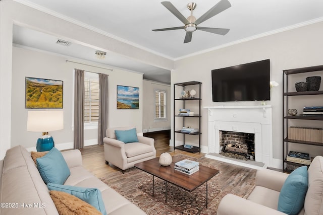 living room featuring crown molding, ceiling fan, and hardwood / wood-style flooring