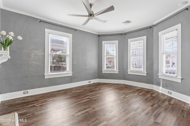 empty room featuring crown molding, ceiling fan, and dark hardwood / wood-style floors