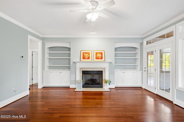 unfurnished living room with crown molding, ceiling fan, dark wood-type flooring, and built in features