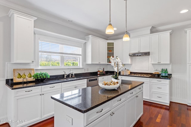 kitchen with white cabinetry, sink, a kitchen island, and appliances with stainless steel finishes