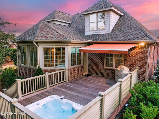 deck at dusk featuring area for grilling