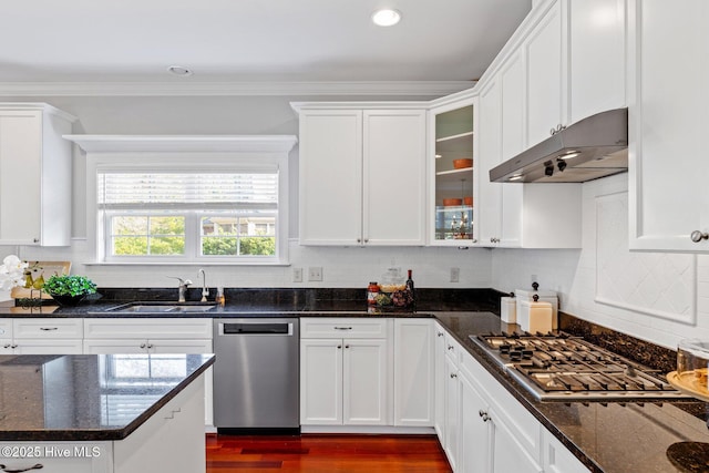 kitchen featuring white cabinetry, stainless steel appliances, sink, and dark stone countertops