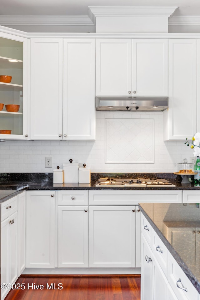 kitchen featuring tasteful backsplash, gas stovetop, ornamental molding, white cabinets, and dark stone counters