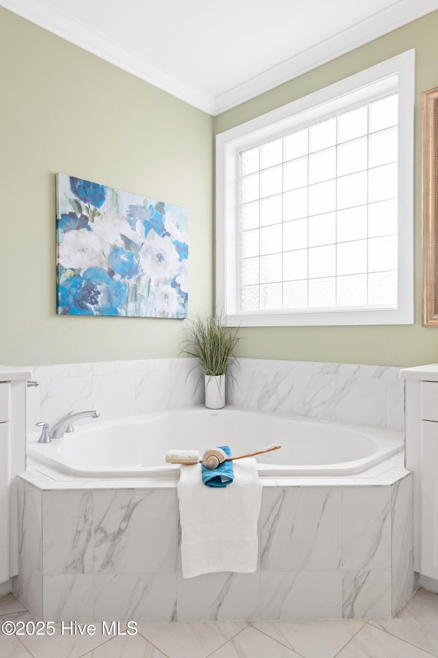 bathroom with vanity, tiled tub, and ornamental molding