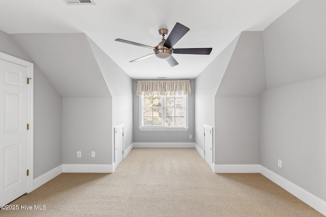 additional living space with light carpet, lofted ceiling, and ceiling fan