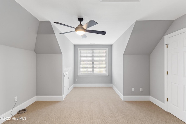 bonus room with ceiling fan, lofted ceiling, and light carpet