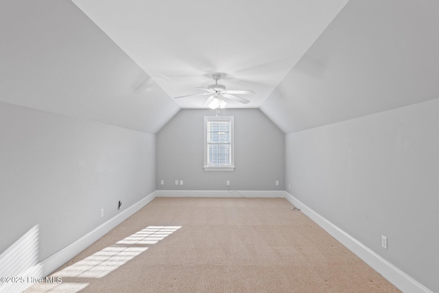 bonus room featuring vaulted ceiling, light carpet, and ceiling fan