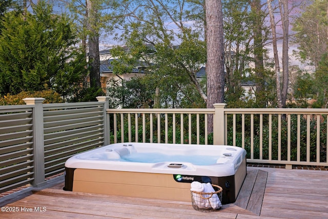 wooden terrace with an outdoor hot tub