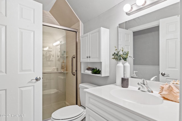 bathroom with walk in shower, vanity, and toilet