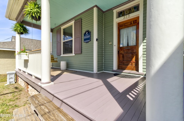 view of exterior entry featuring a porch