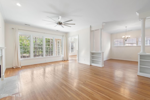 unfurnished living room with ceiling fan with notable chandelier, ornamental molding, light hardwood / wood-style floors, and ornate columns