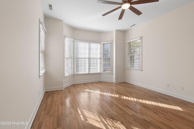 unfurnished room with ceiling fan and light wood-type flooring