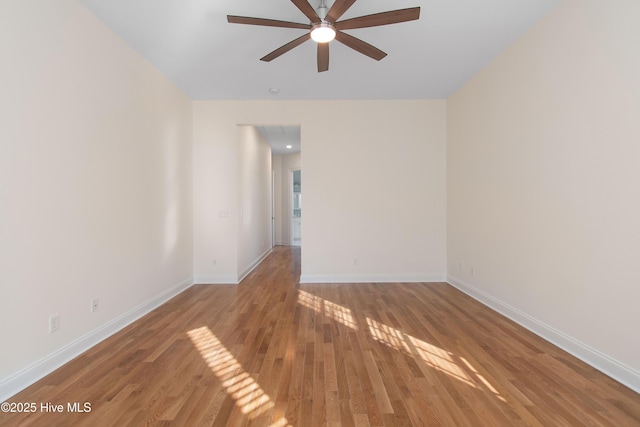 spare room with wood-type flooring and ceiling fan