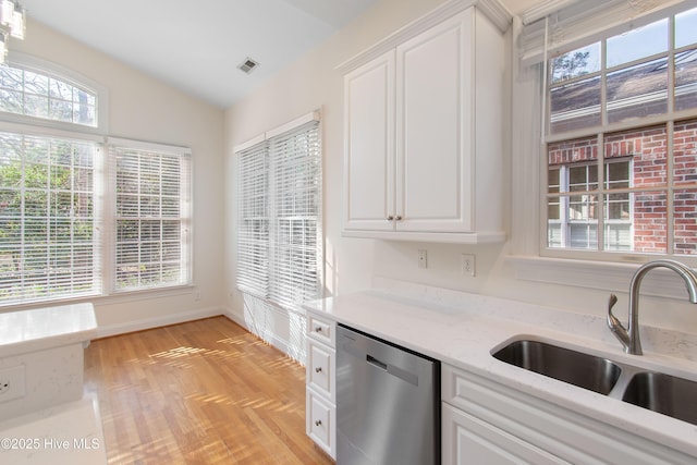 kitchen with white cabinetry, sink, vaulted ceiling, and stainless steel dishwasher