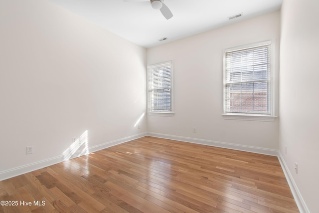 unfurnished room with hardwood / wood-style flooring and ceiling fan