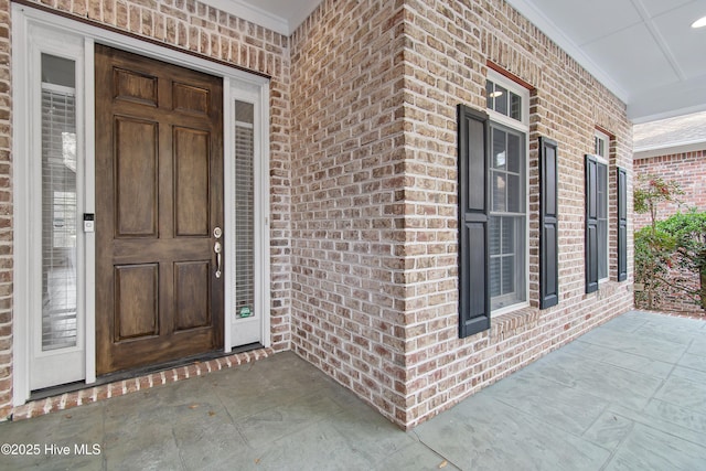 view of exterior entry featuring a porch