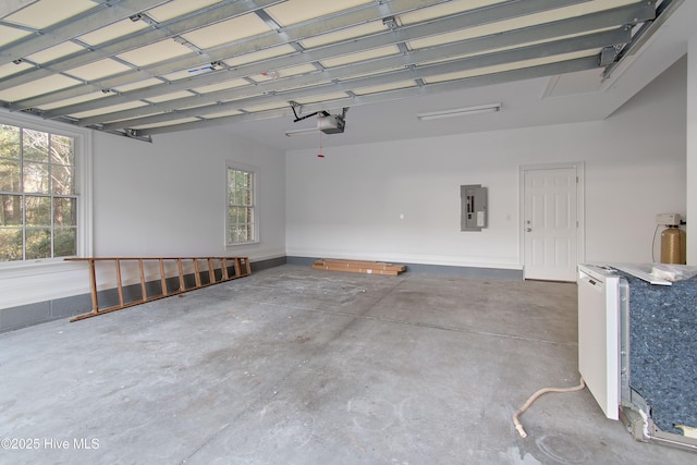 garage with a garage door opener and electric panel