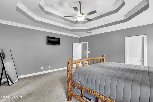 bedroom with ornamental molding, a raised ceiling, ceiling fan, and carpet flooring