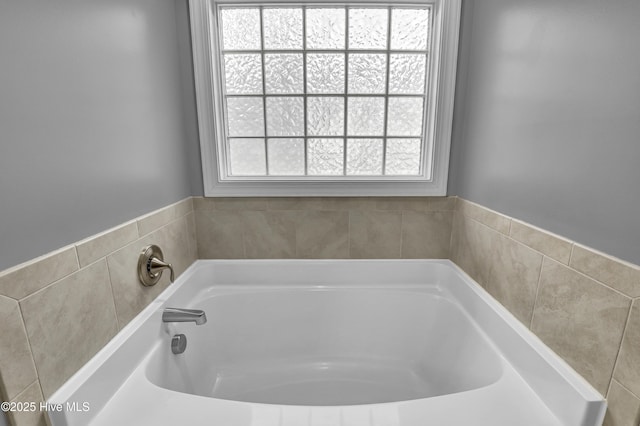 bathroom featuring a tub to relax in