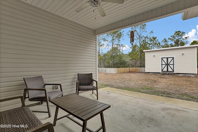 view of patio / terrace with ceiling fan and a storage shed