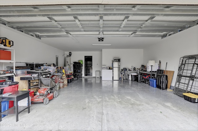 garage featuring washing machine and clothes dryer, a garage door opener, and refrigerator