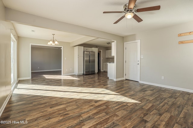 unfurnished room featuring ceiling fan with notable chandelier and dark hardwood / wood-style floors