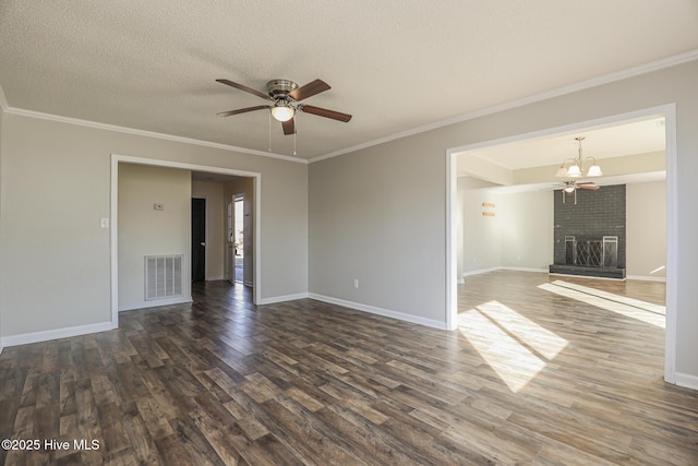 unfurnished room with ornamental molding, a textured ceiling, a fireplace, and dark hardwood / wood-style flooring