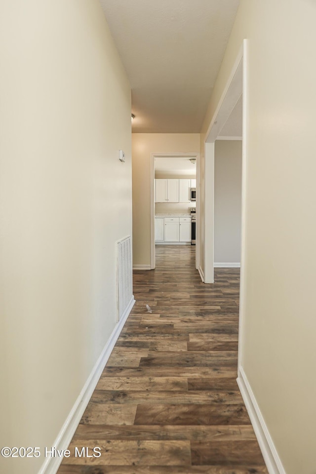 hall with dark hardwood / wood-style flooring